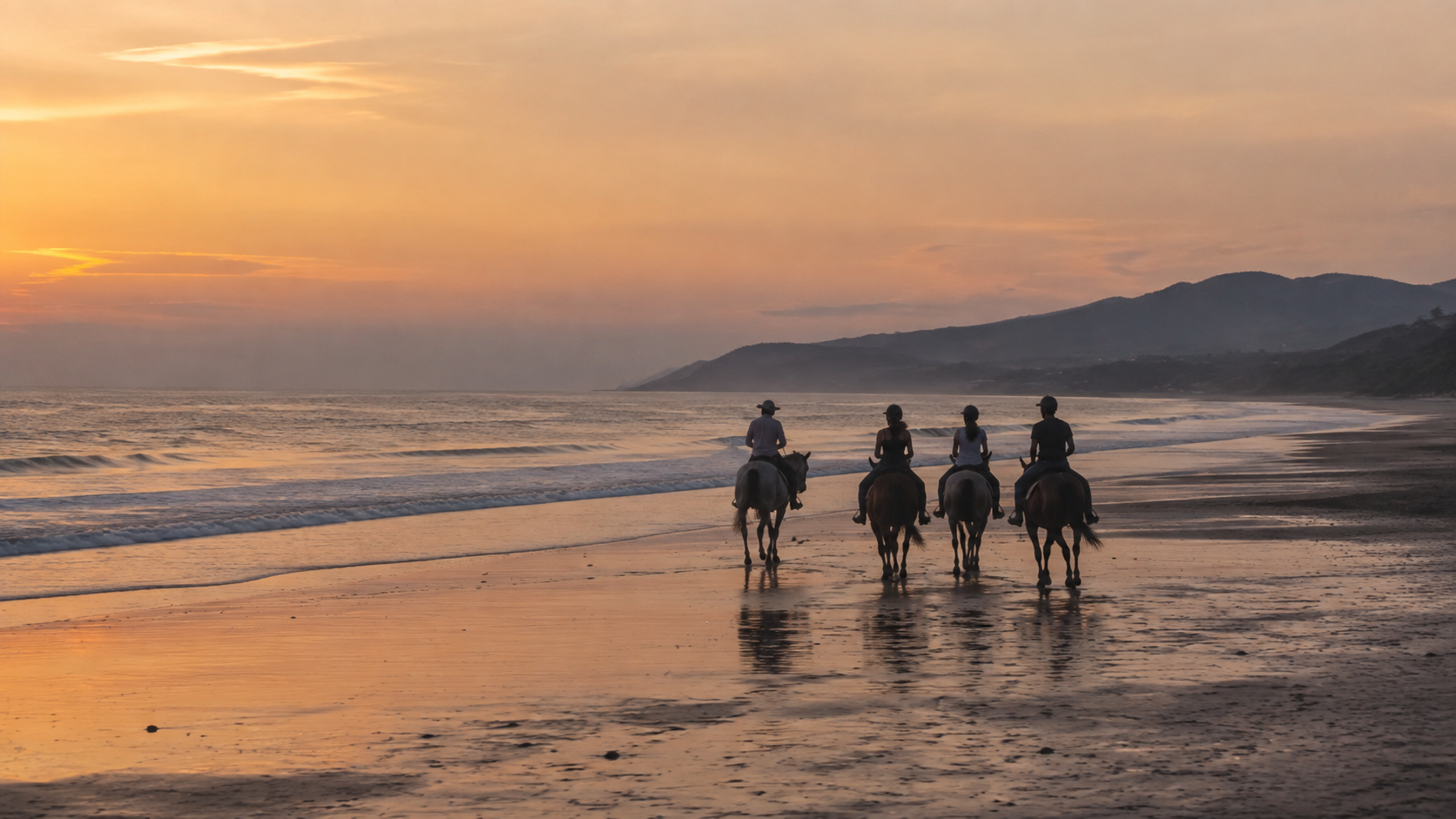 Four travelers riding horses along a Salvadoran beach at sunset.