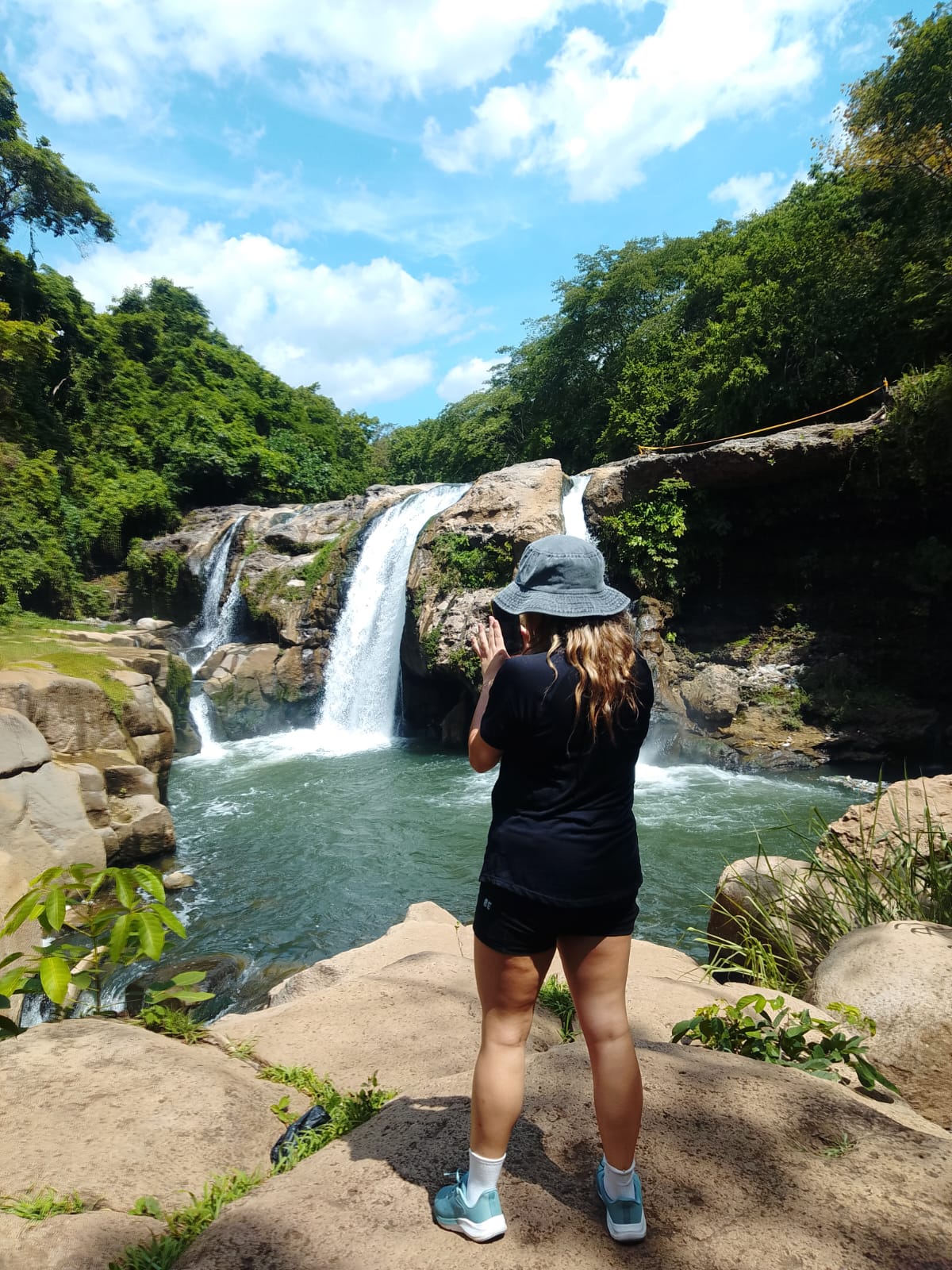 Traveler admiring a hidden waterfall in the Salvadoran jungle