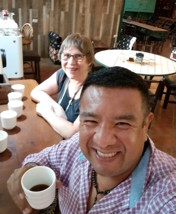 VIP Tours El Salvador guide enjoying coffee with a guest at a coffee farm