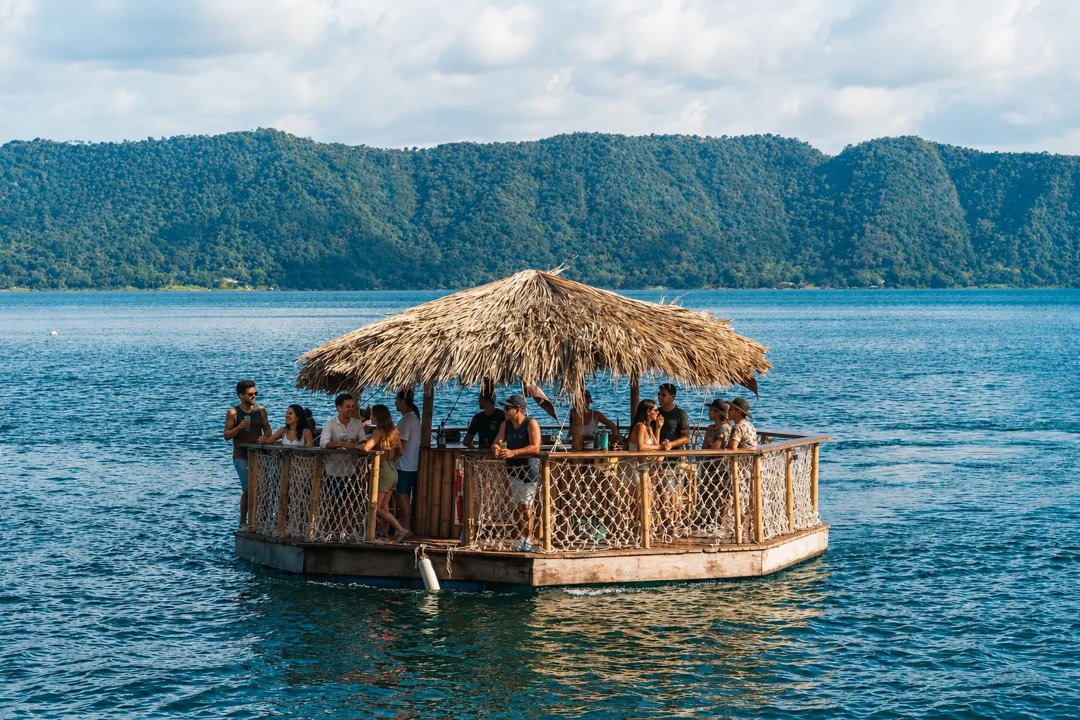 A corporate group relaxing together on a private floating thatched bar on Lake Coatepeque, El Salvador