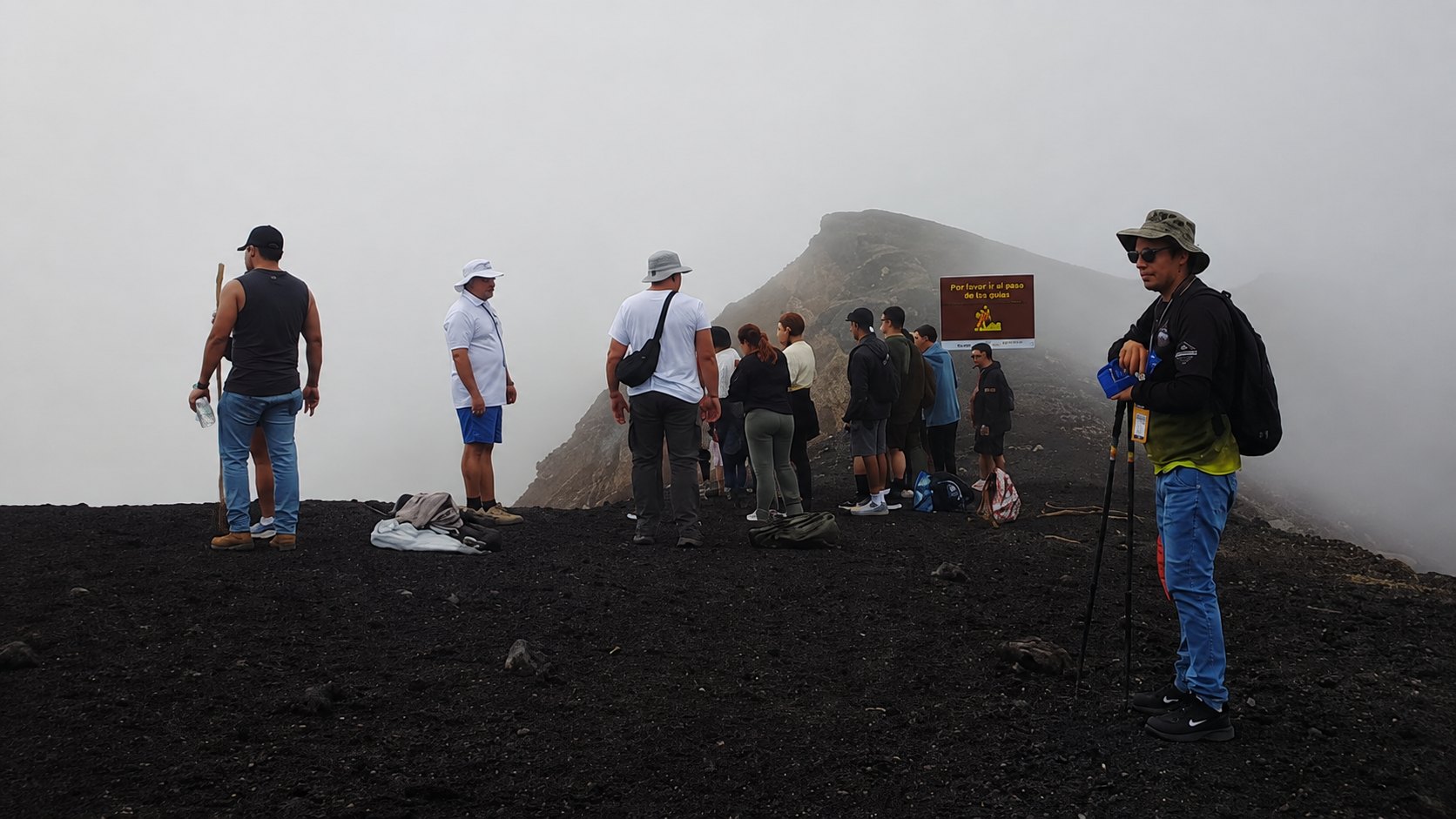 Authorized local guide assisting hikers at Santa Ana Volcano in El Salvador
