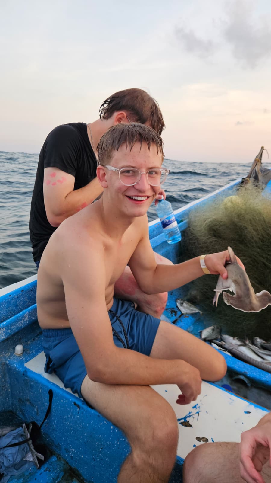 Guest fishing at sunrise on the Pacific coast with local fishermen