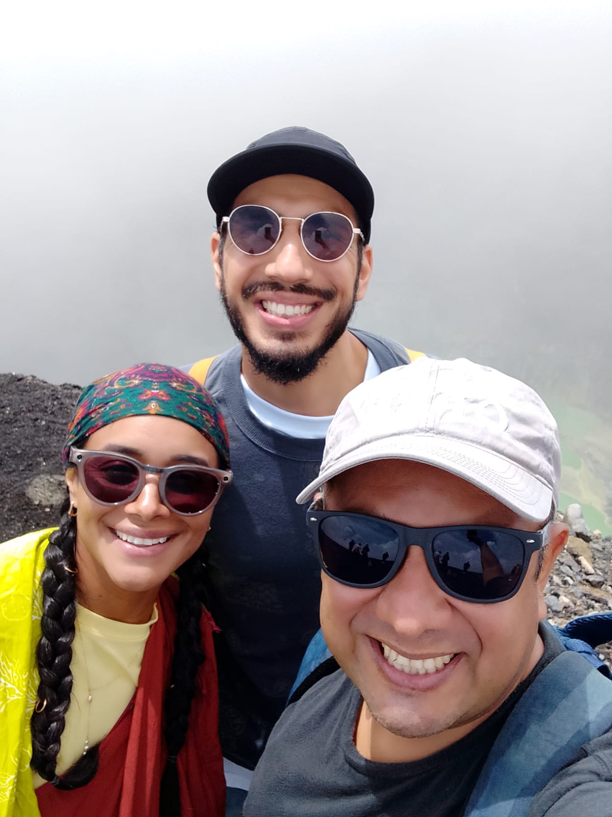 Three guests smiling at the Ilamatepec crater rim